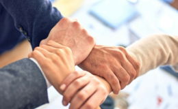 person in black long sleeve shirt holding persons hand