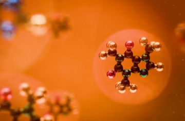 Molecular structures are seen against an orange backdrop.